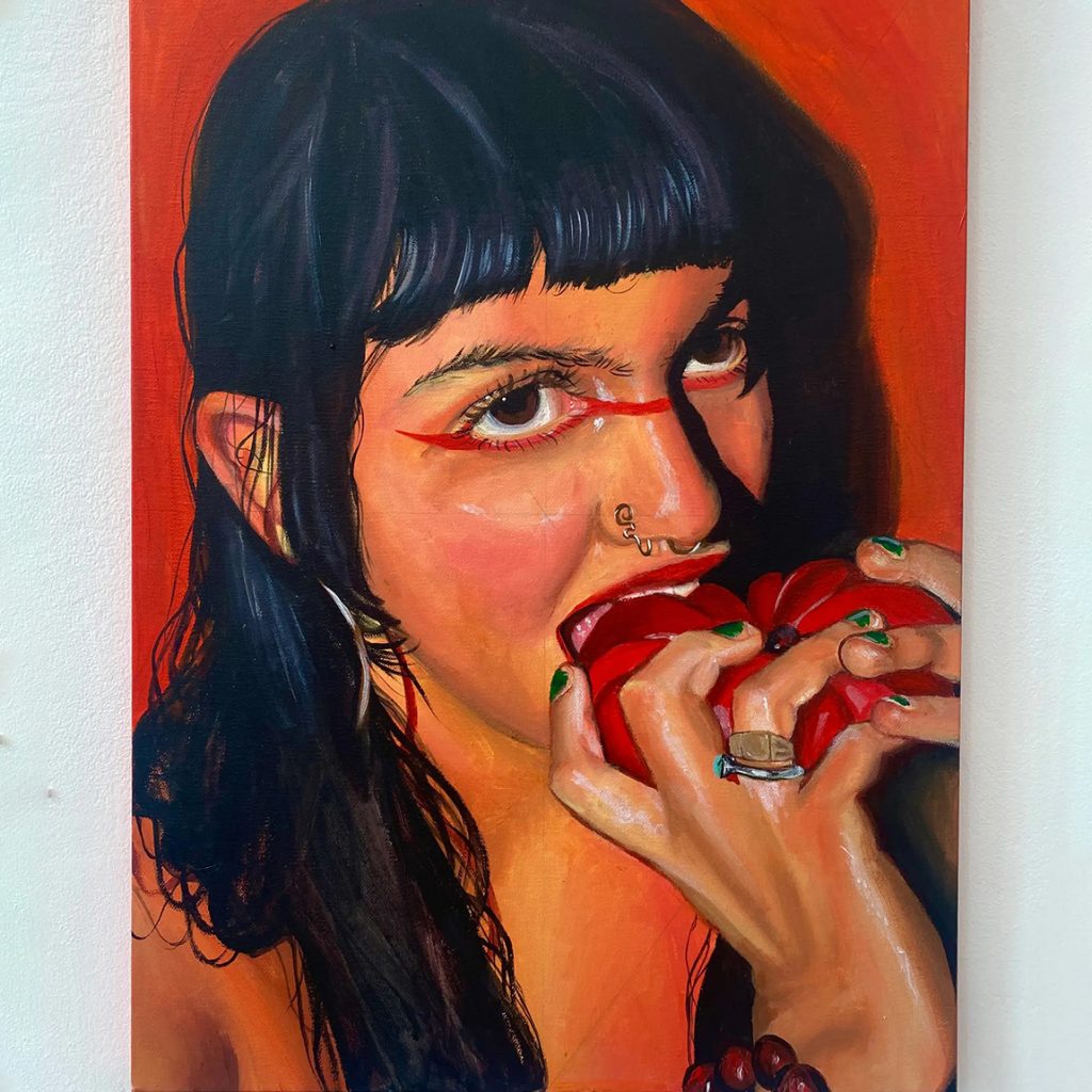 Student work by Yasmin Shah. Large painted image of someone taking a bite out of a red fruit