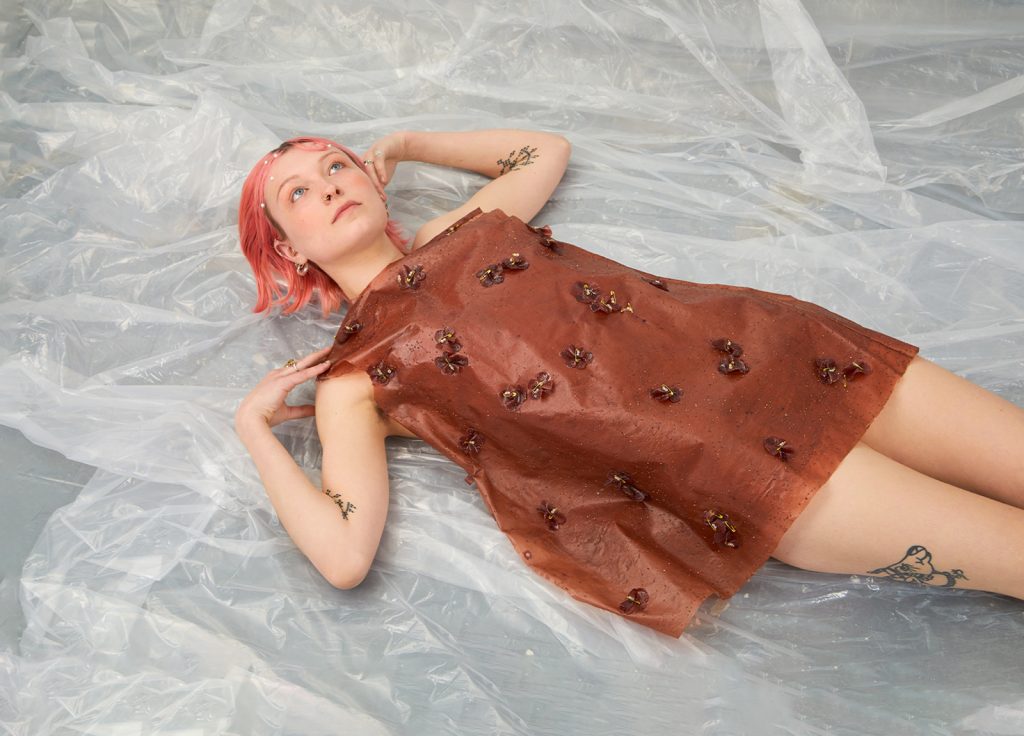 Student work by Molly Green. Model wears a dress with 'fabric' made from strawberries