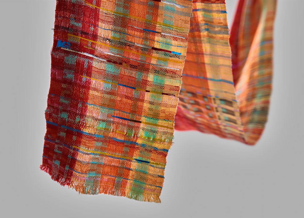 Student work by Bee Hale. Delicate woven fabric in orange and green