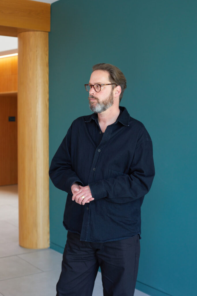 Staff portrait of Liam Wells wearing a black shacket and black jeans