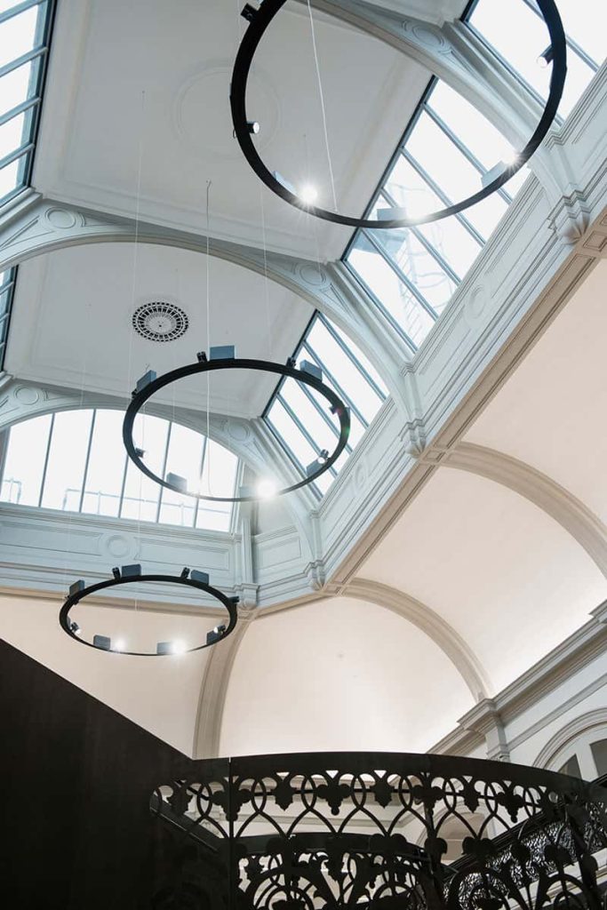 photo of Norwich University of the Arts building boardman house shows atrium skylight with large amounts of light pouring in and circle lighting fixtures