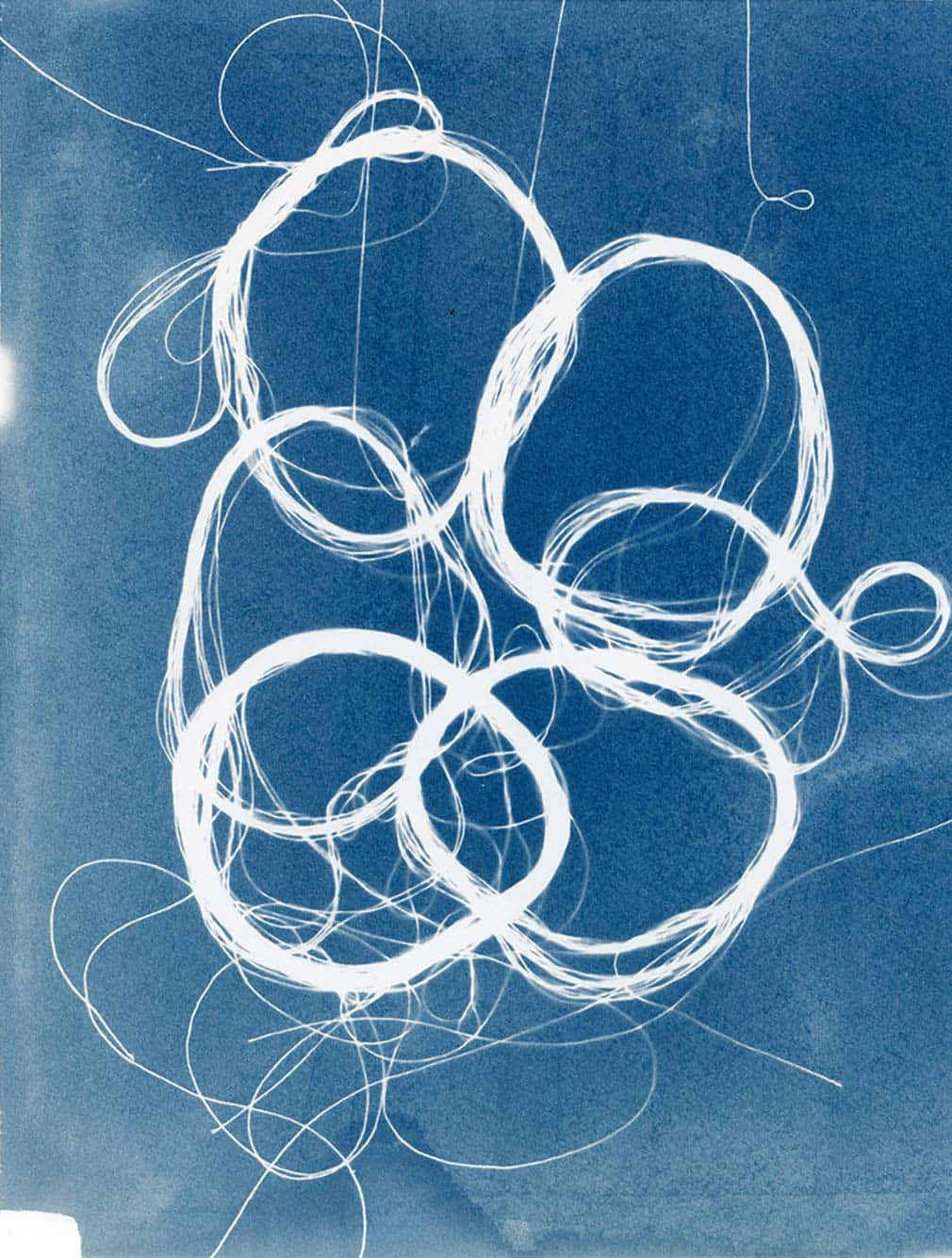 Blurry blue background with cyanotype white string