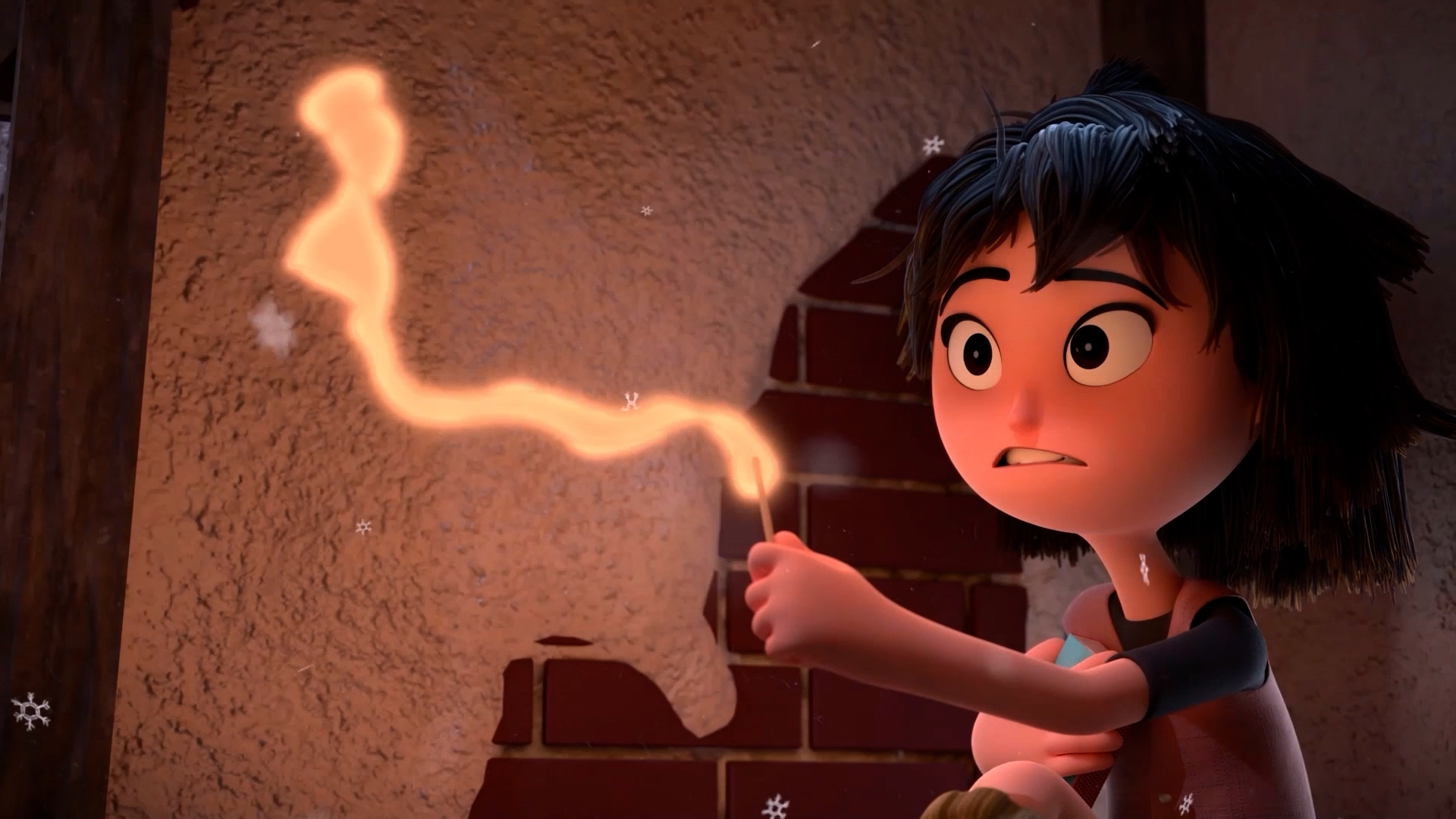 A young animated character with short black hair and wide eyes nervously holds a lit matchstick that emits a glowing, wavy line of light. The character, created by students in an animation visual effects degree course, sits against a partially brick wall as small snowflakes fall around them.