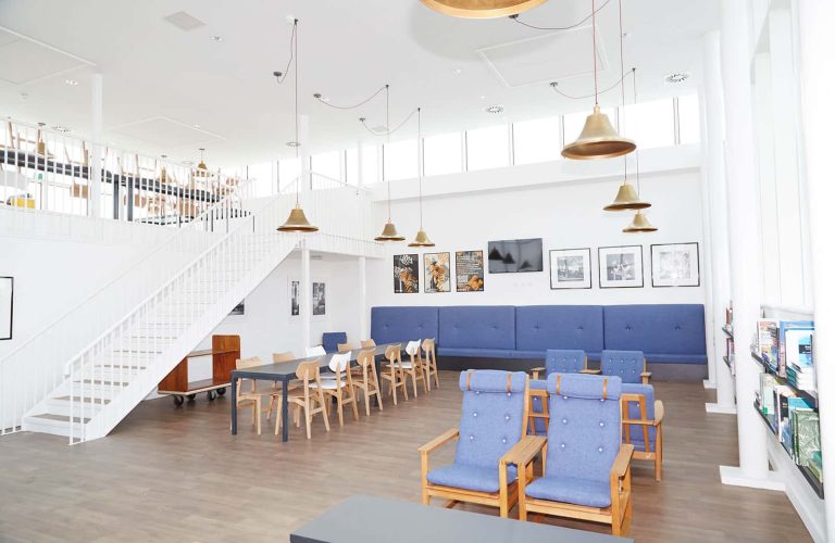 All Saints Green interior showing communal space with chairs and tables at Norwich University of the Arts that you can see on the Open Day