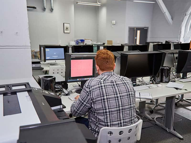 Image of a student working on a computer in the digital darkroom