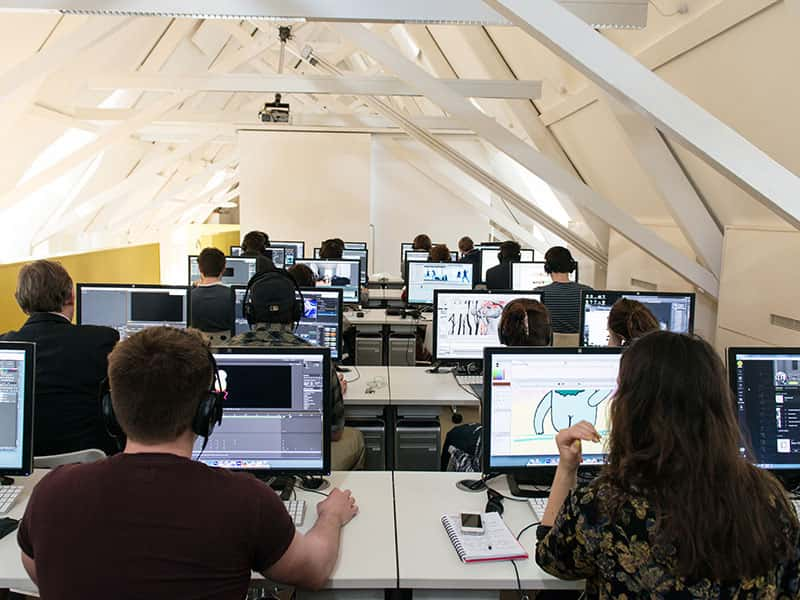 Image of students working on computers in a media lab