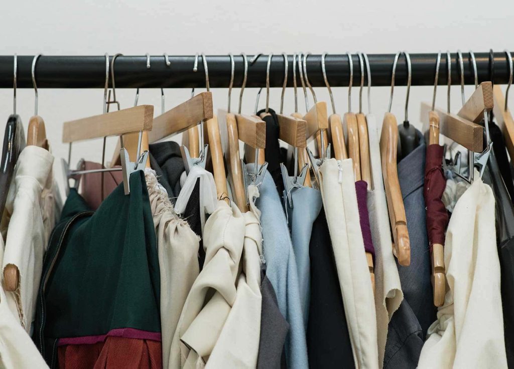 Image of a rack full of hanging garments and toiles made by Norwich University of the Arts Fashion students