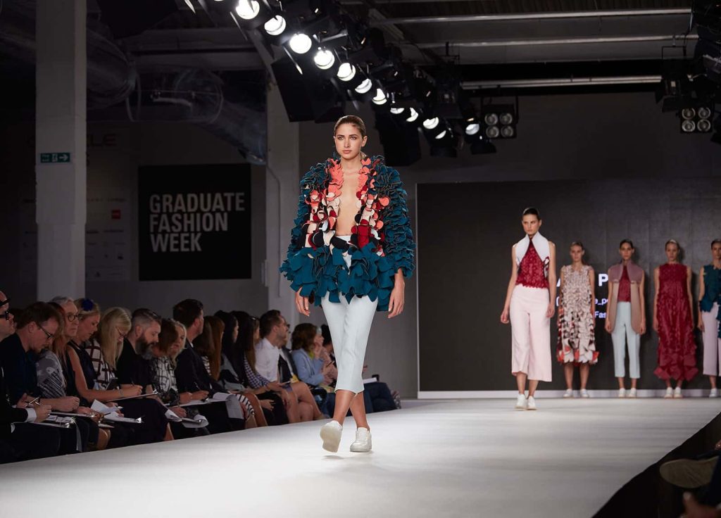 Image of model walking on the catwalk at London Graduate Fashion Week wearing a lasercut design by student Alice Potts