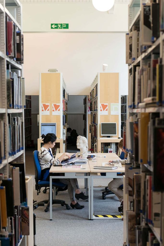 Image of a student working at a desk in the library