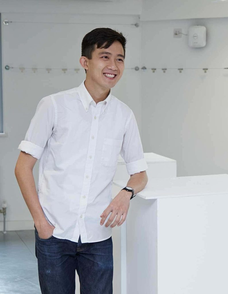 Mark Ng wearing a white shirt and smiling