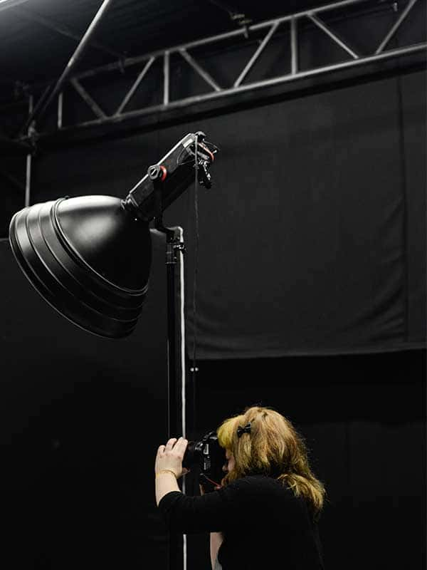 Image of a student taking a picture in the Norwich University of the Arts Photography studio