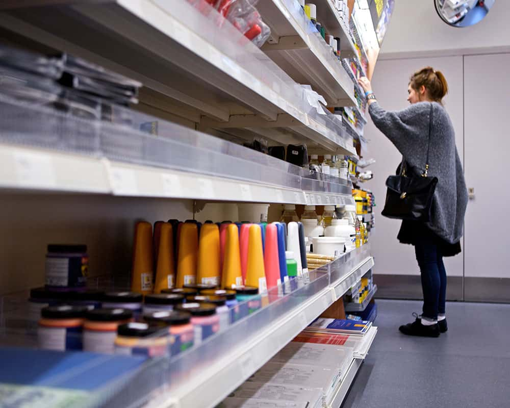 Image of a student looking at items in the Norwich University of the Arts Shop