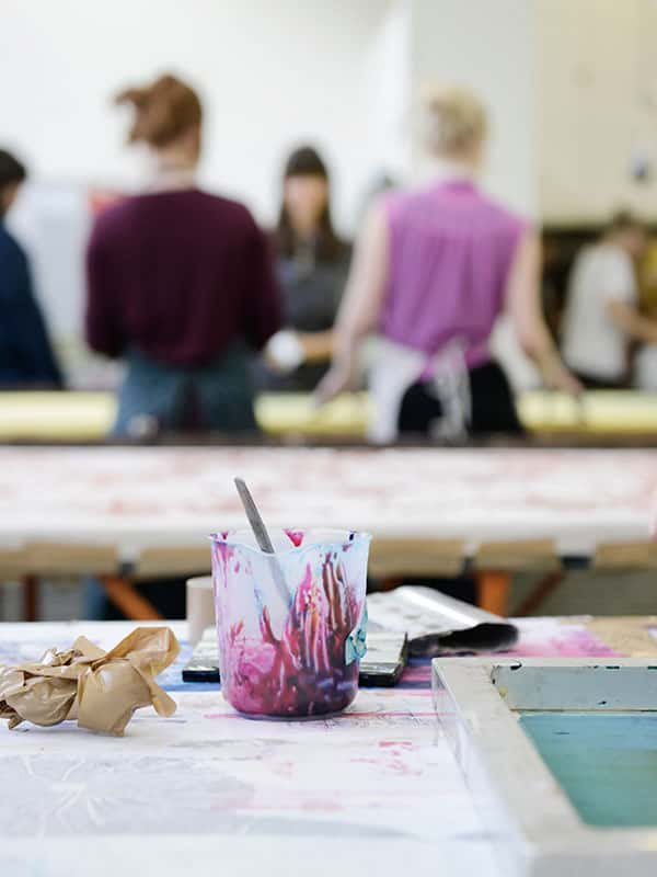 Image of a plastic jug on ink sitting on a screen printing bed