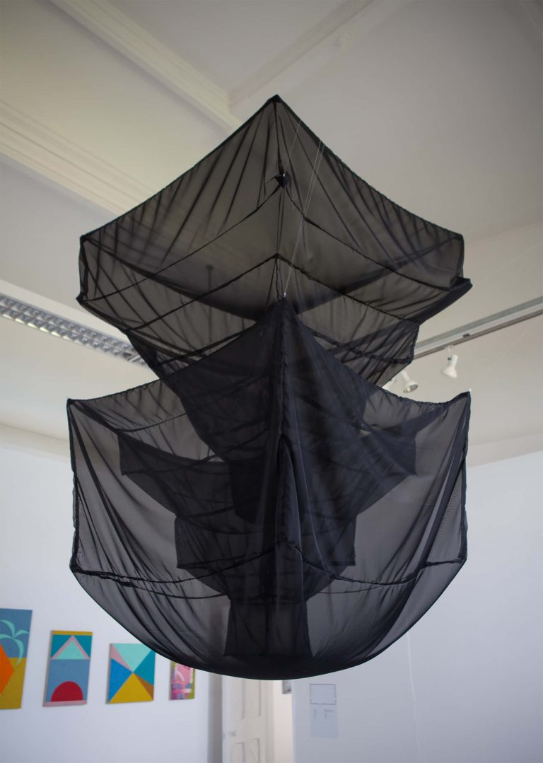 Photograph of large geometric black mesh sculpture hanging from ceiling in BA Degree Show 2017