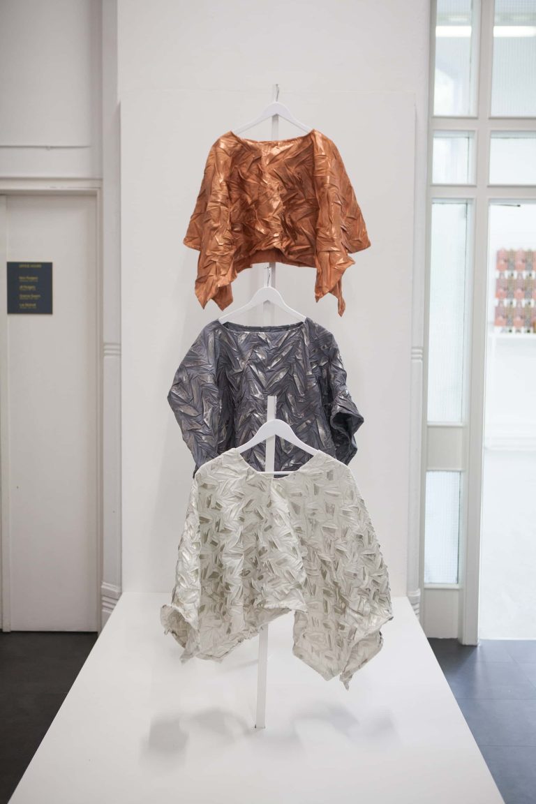 Three textile design garments hanging in the BA Degree Show 2017