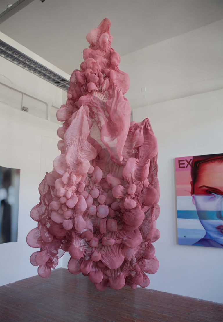 Large pink sculpture hanging from ceiling in 2017 BA Degree Show