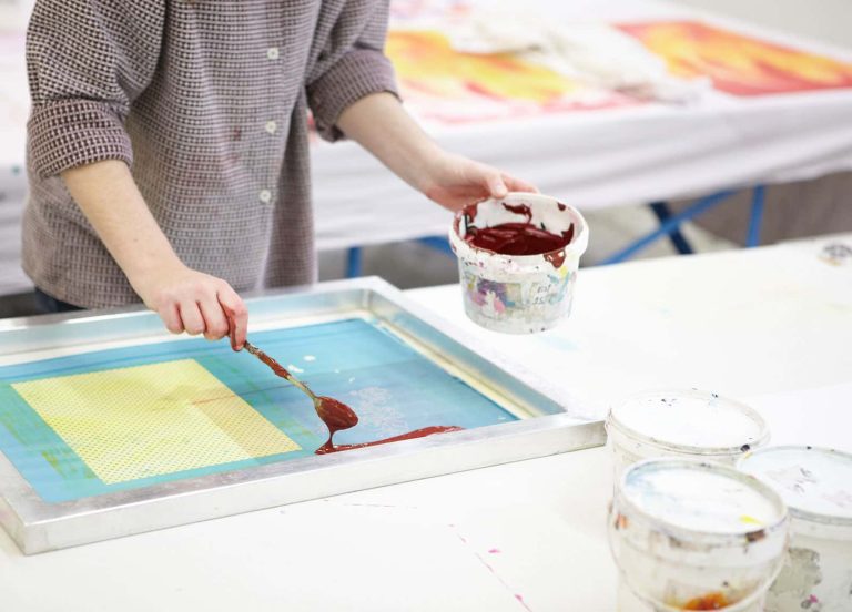 Image of a student pouring ink onto a screen bed