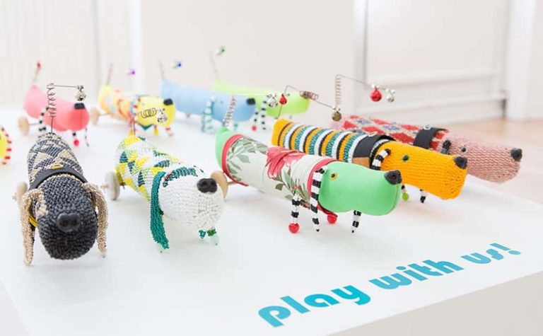 Work by Norwich University of the Arts Research student Kazz Morohashi showing 9 dog puppets in multiple colours