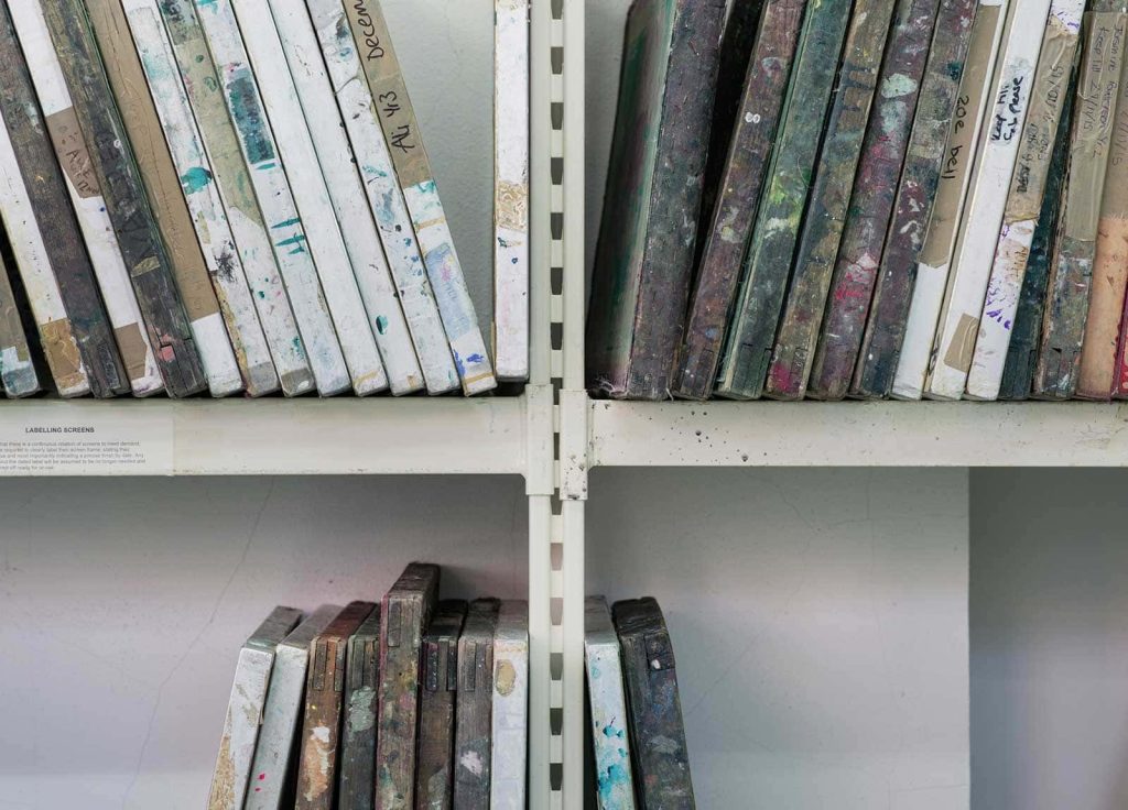 Image of a row of screens stacked on shelving in Norwich University of the Arts's workshop