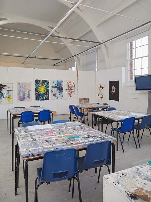 Fine Art Painting Studio at Norwich University of the Arts, showing a creative painting space including chairs and easels by a window