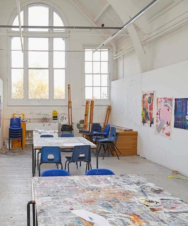 Fine Art Painting Studio at Norwich University of the Arts, showing a creative painting space including chairs and easels by a window