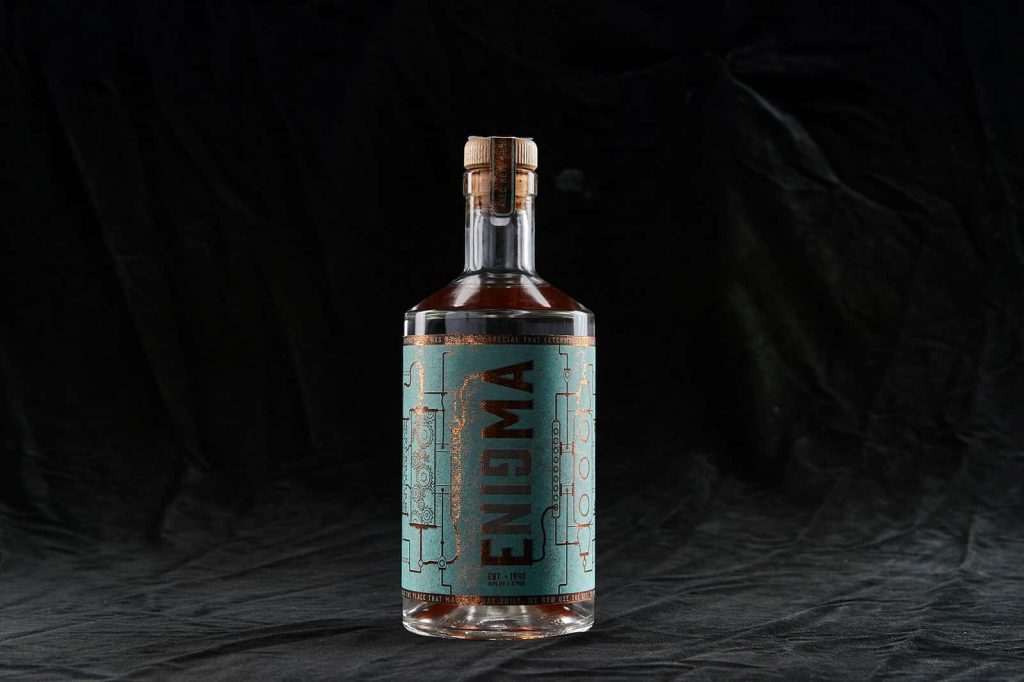 Designed gin bottle with the words 'Enigma' on by BA Graphic Design graduate Tom Baines