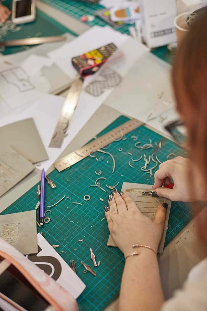 Students paper cutting in the year 0 studios at Norwich University of the Arts