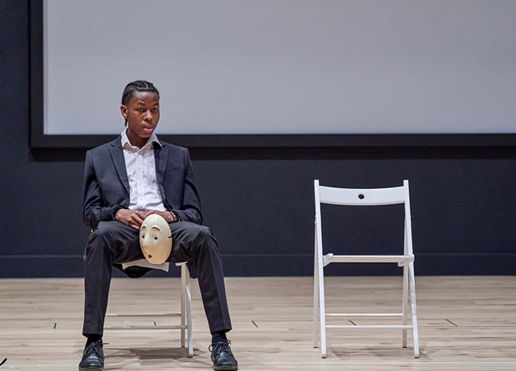 Student sitting on folding chair