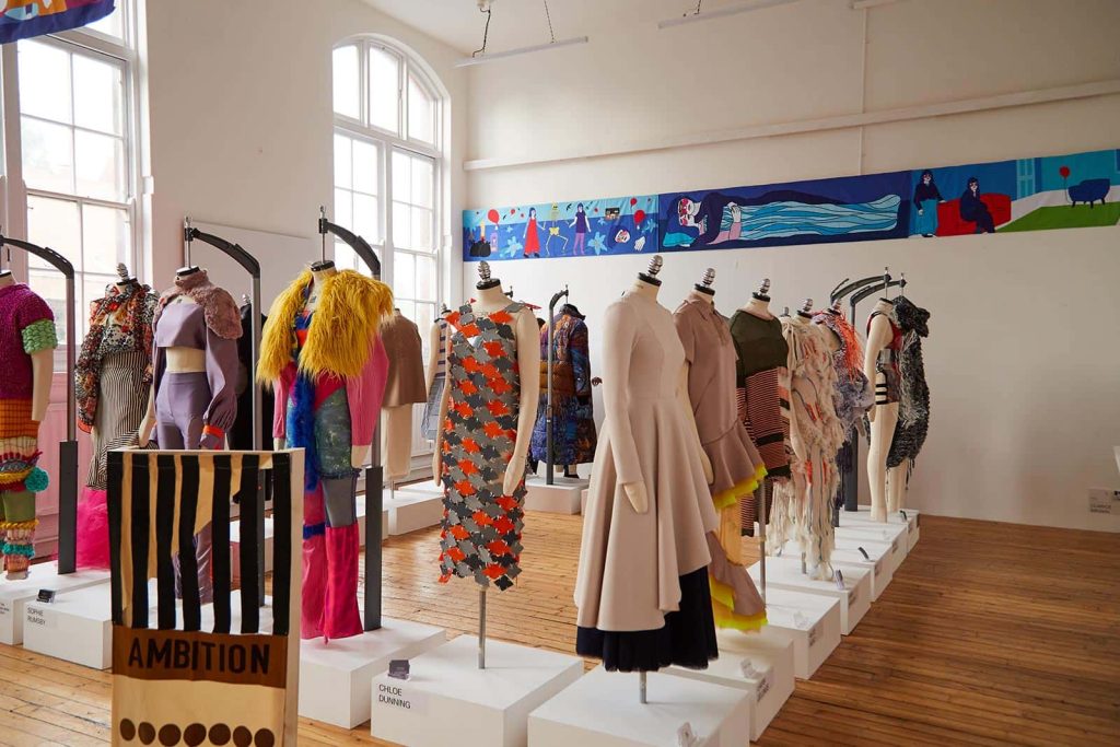 Mannequins holding garments within the BA Fashion Norwich University of the Arts of all different colours and types