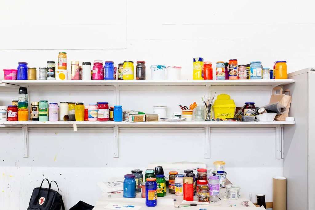 Colourful messy paint pots in the Norwich University of the Arts print studio