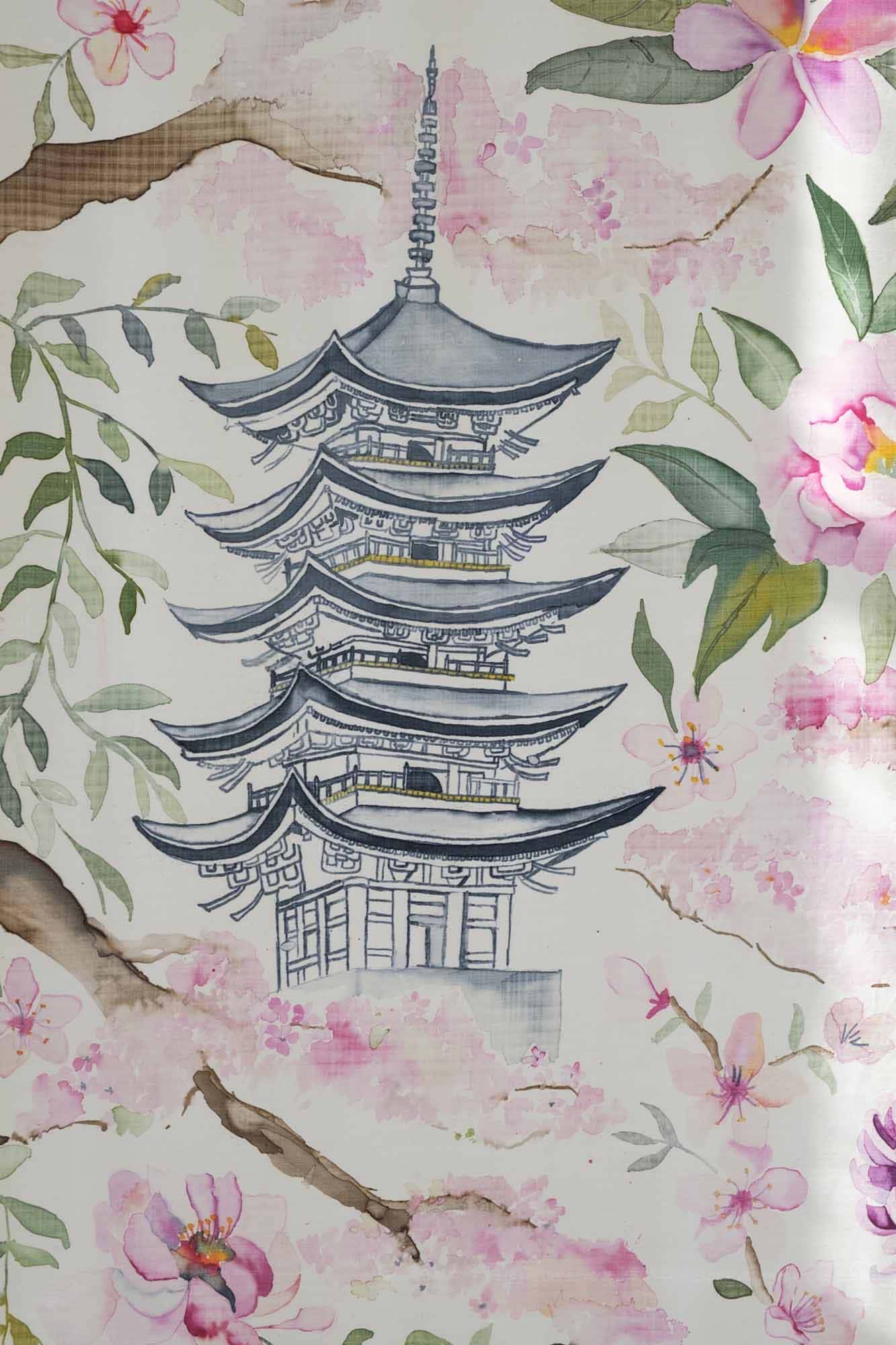 Close up of a printed piece of silk showing a Japanese tiered building surrounded by green leaves and pink flowers