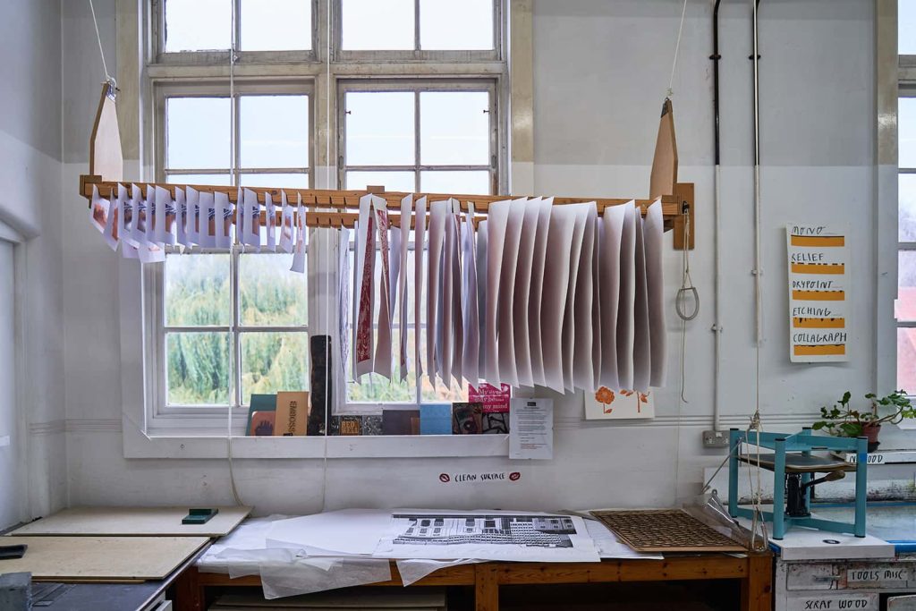 Paper drying with paint on, in the Norwich University of the Arts Printmaking Workshop