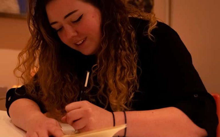 BA (Hons) Architecture graduate Olivia Elsey sketching at a desk