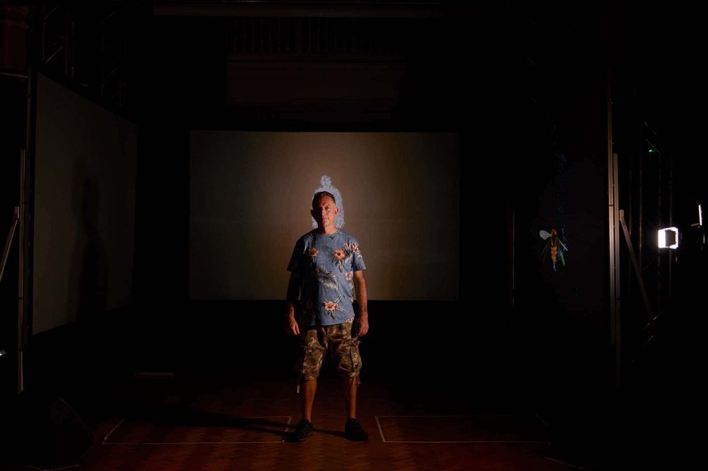 Jamie Gledhill stands in front of a screen