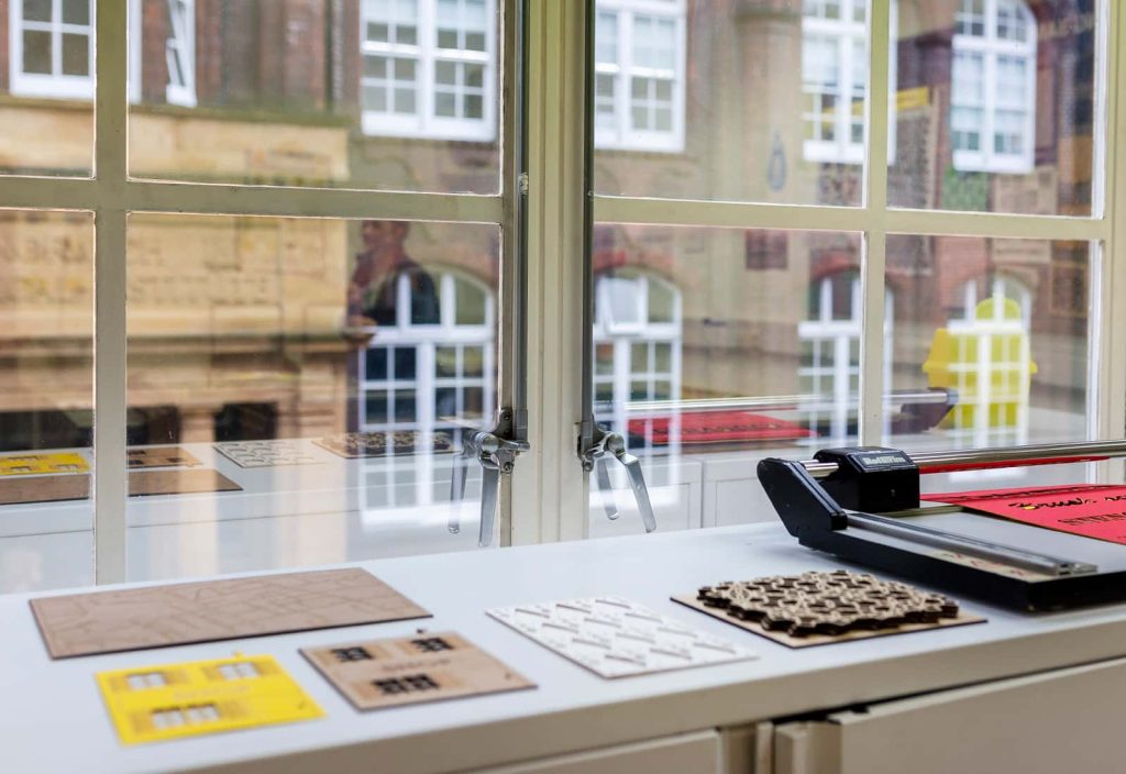 Students' work laid out in the daylight on a work surface in the digital design studios