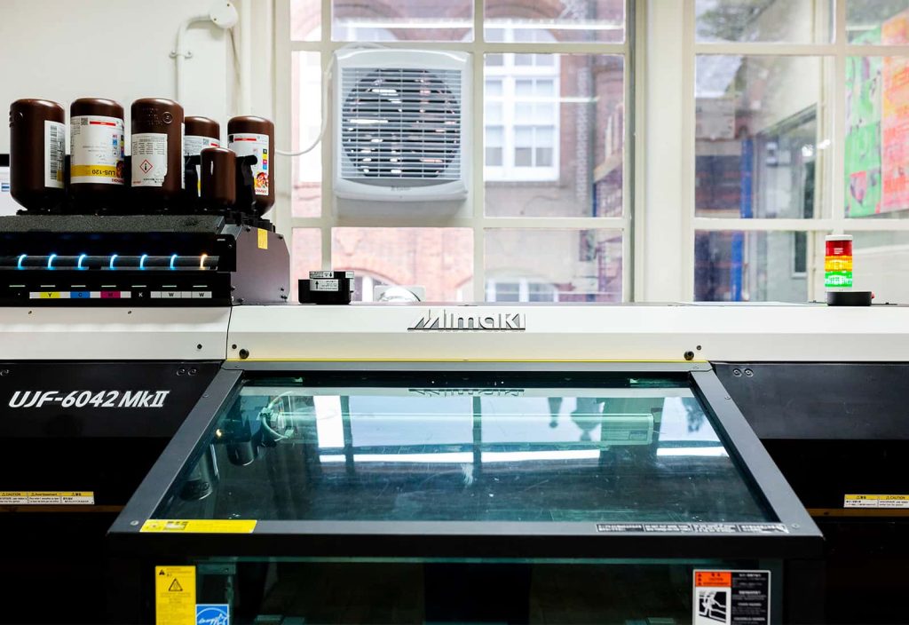 The UV printer in the Large Format Print Room can print on to a range of materials like aluminium, glass, and canvas, as well as completely cylindrical materials like bottles.