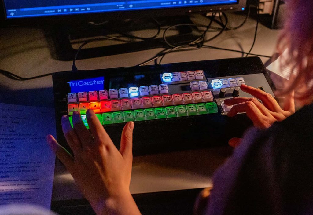 A student uses the illuminated keyboard for the film students specialist equipment