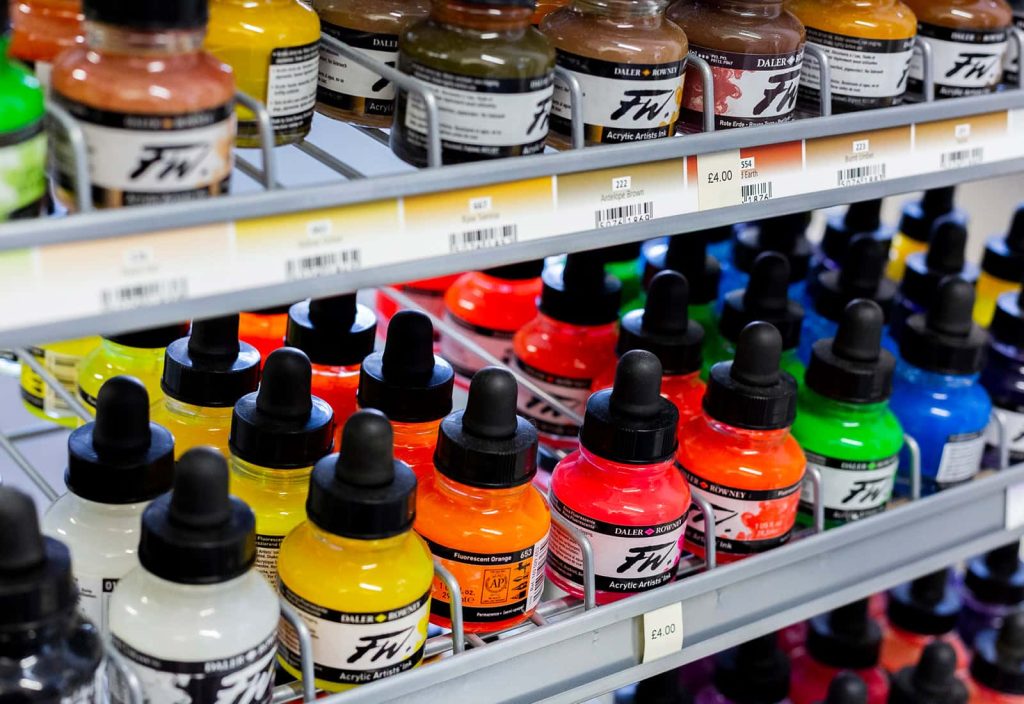 A range of vibrant acrylic FW inks on shelves at the shop