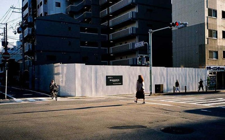 A person walking across a crossing in Kyoto