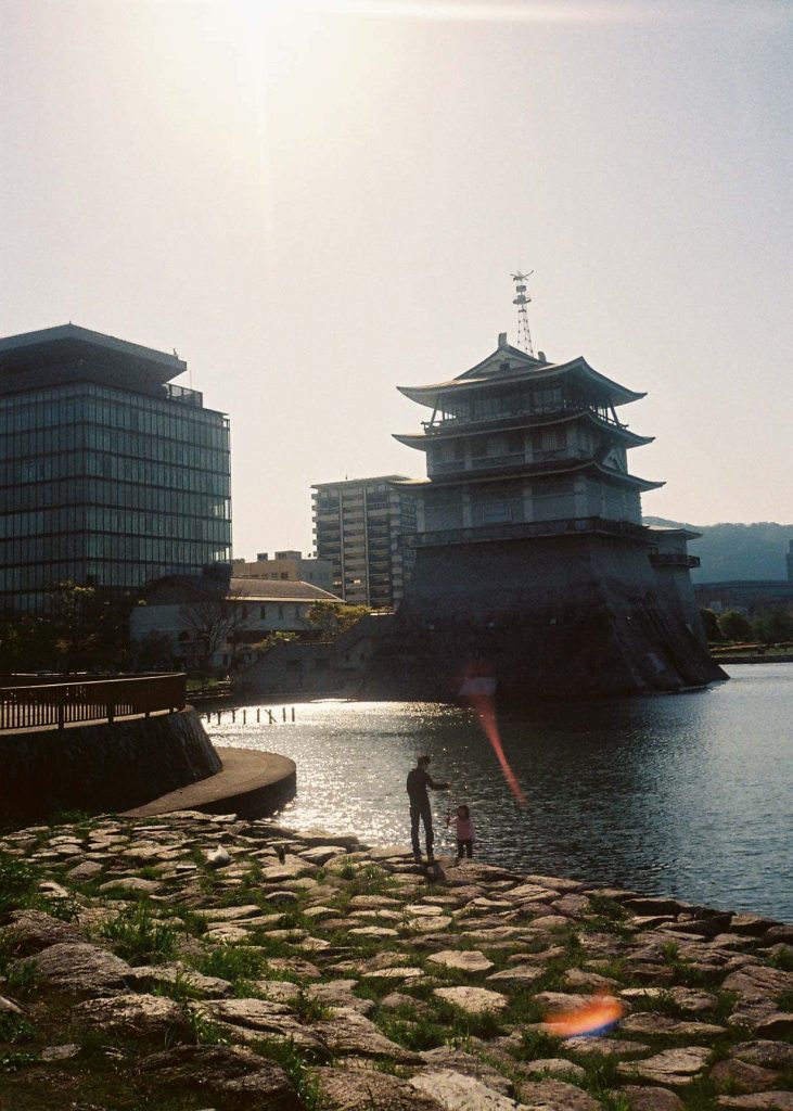 2 people playing by the shore by Biwa temple, Kyoto