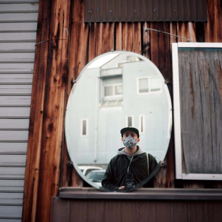 Photography graduate Karim Skalli taking a selfie in a passing mirror