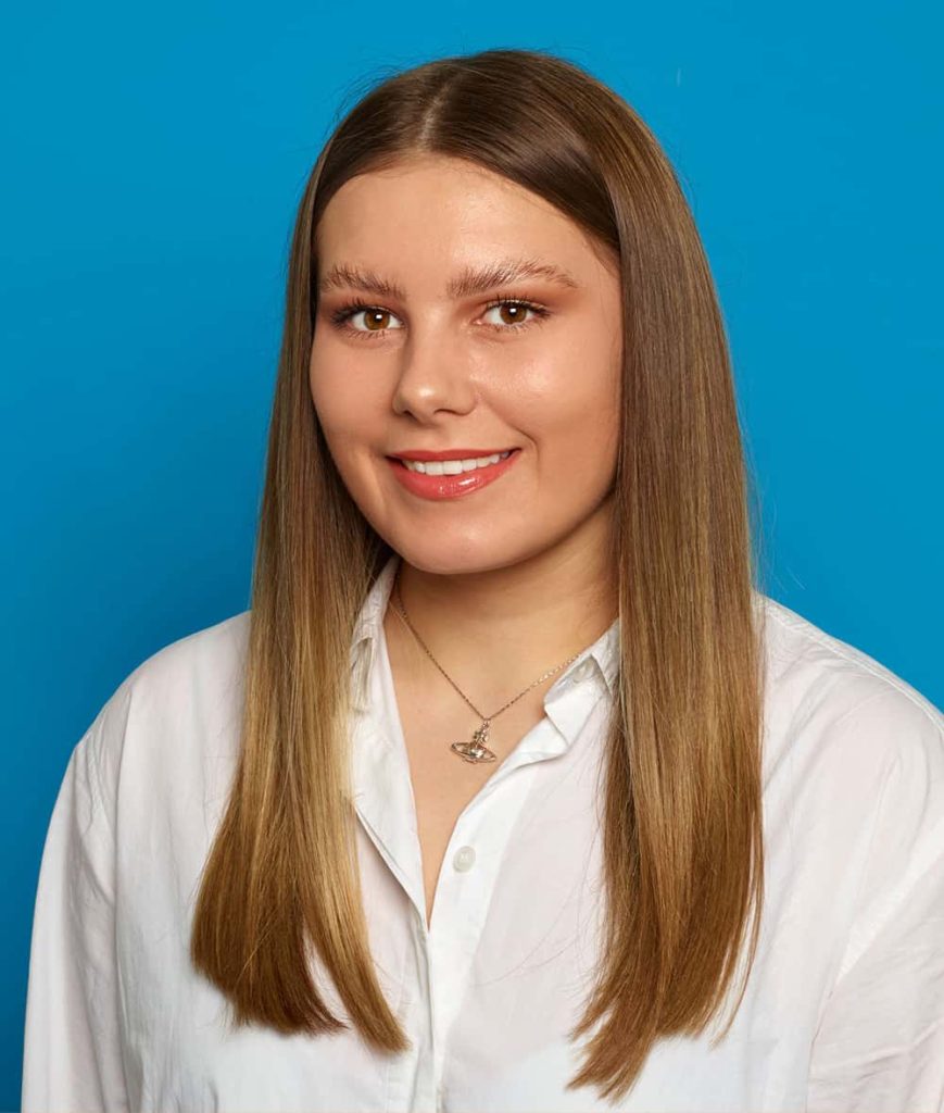 Image showing person with long blonde/brown hair wearing a white shirt and necklace