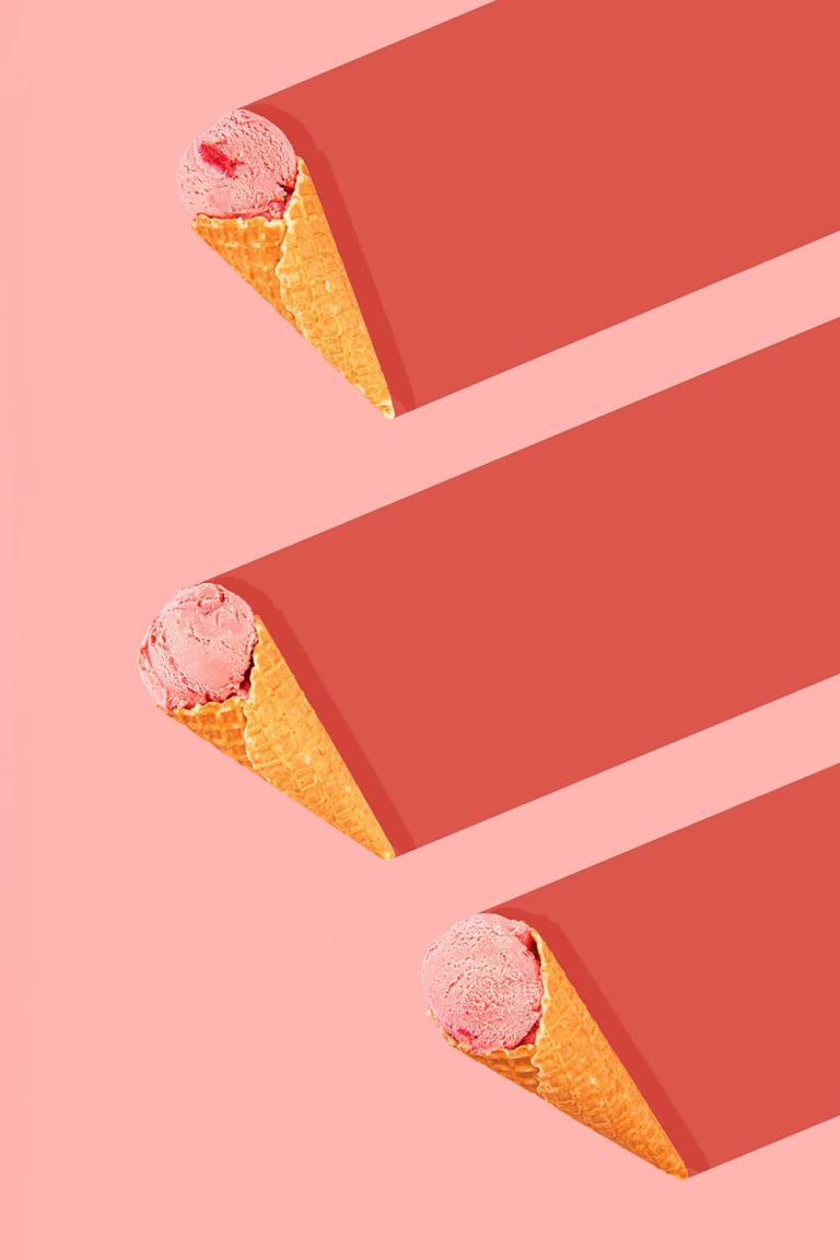 Photograph showing 3 icecream cones with pink icecream sitting on a pink backdrop with red shadows.