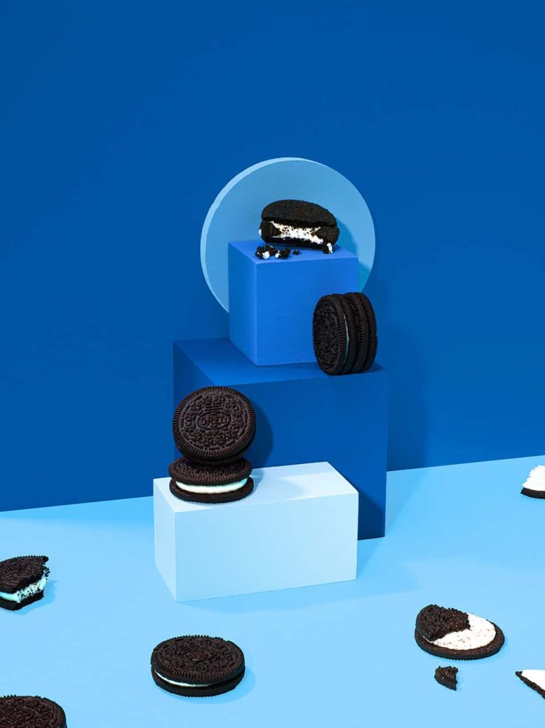 Photograph showing oreo biscuits on 3 blue plinths on a blue backdrop.