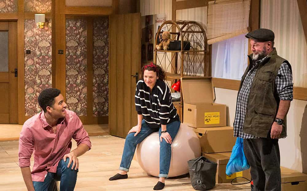 Image showing 3 characters sitting and standing in a farmhouse living room set