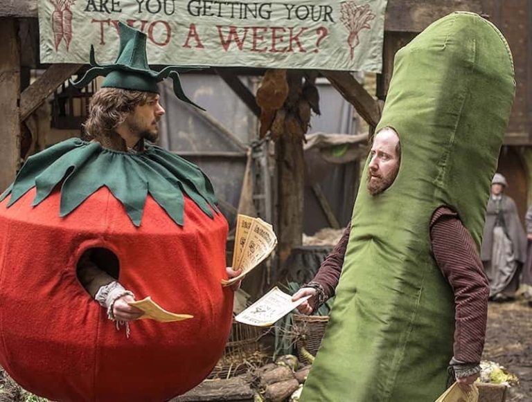 Screen shot from BBC Film Bill showing 2 characters wearing a tomato and cucumber outfit handing out flyers