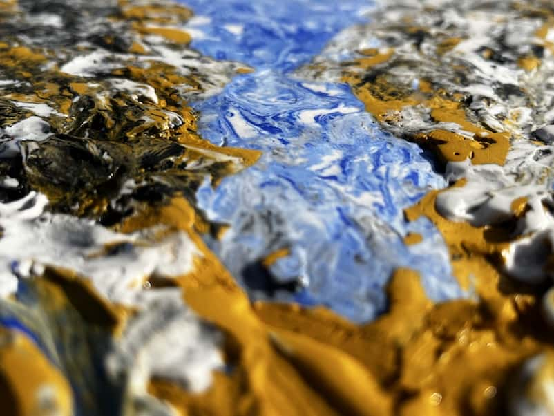 Image of close up of painting made with plaster and acrylic with blue and gold textures