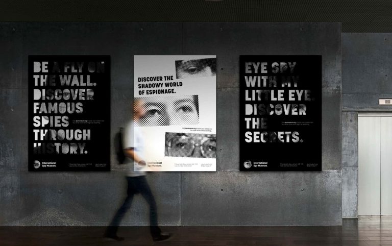 Image showing person walking past wall of black and white posters