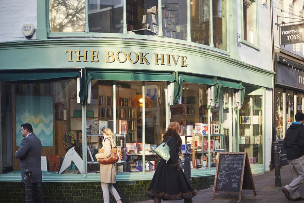 Image showing Book Hive corner shop book shop with books in window and people walking past