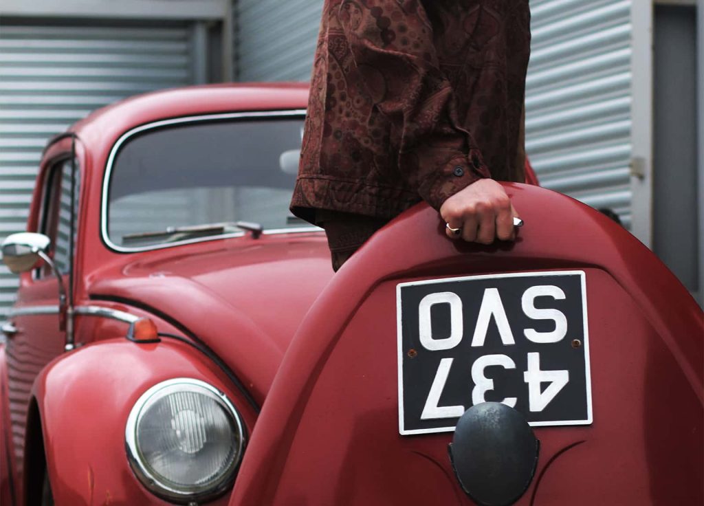 Portrait of Luke, a classic car restorer from Kent. A Porsche 365 ‚Type A‚ is featured alongside, this is the first production vehicle under the Porsche name. Many components were taken from Volkswagen, Luke is restoring his Beetle as a homage to this.